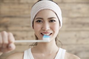 Young woman, toothbrush, toothpaste