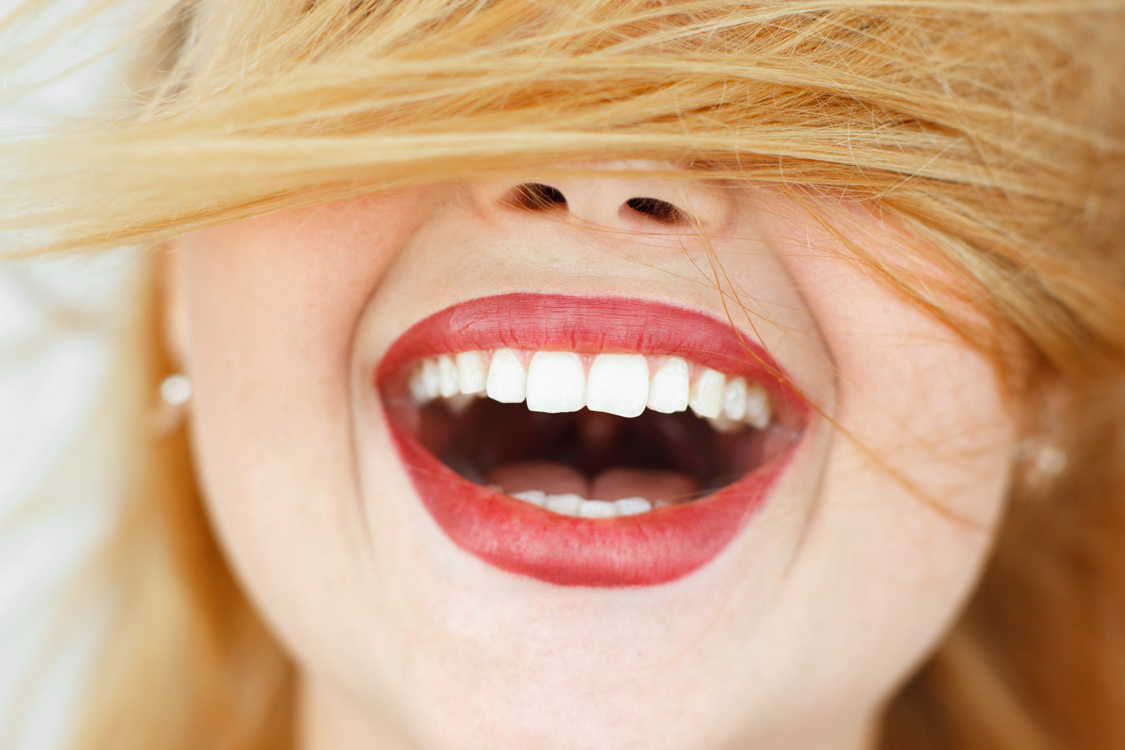 Happy laughing woman with red hair close-up